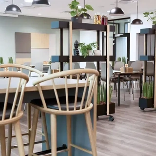 Canteen interior with Scandinavian-style furniture and natural light, designed for modern corporate office dining areas.