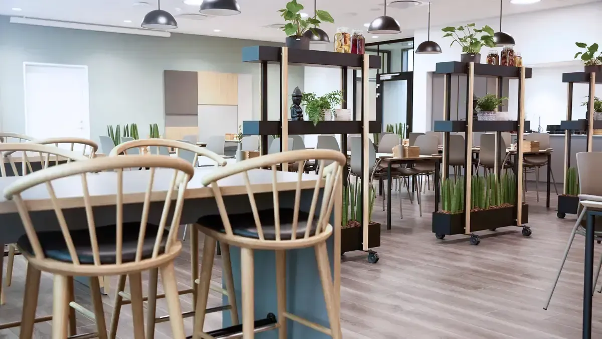 Canteen interior with Scandinavian-style furniture and natural light, designed for modern corporate office dining areas.