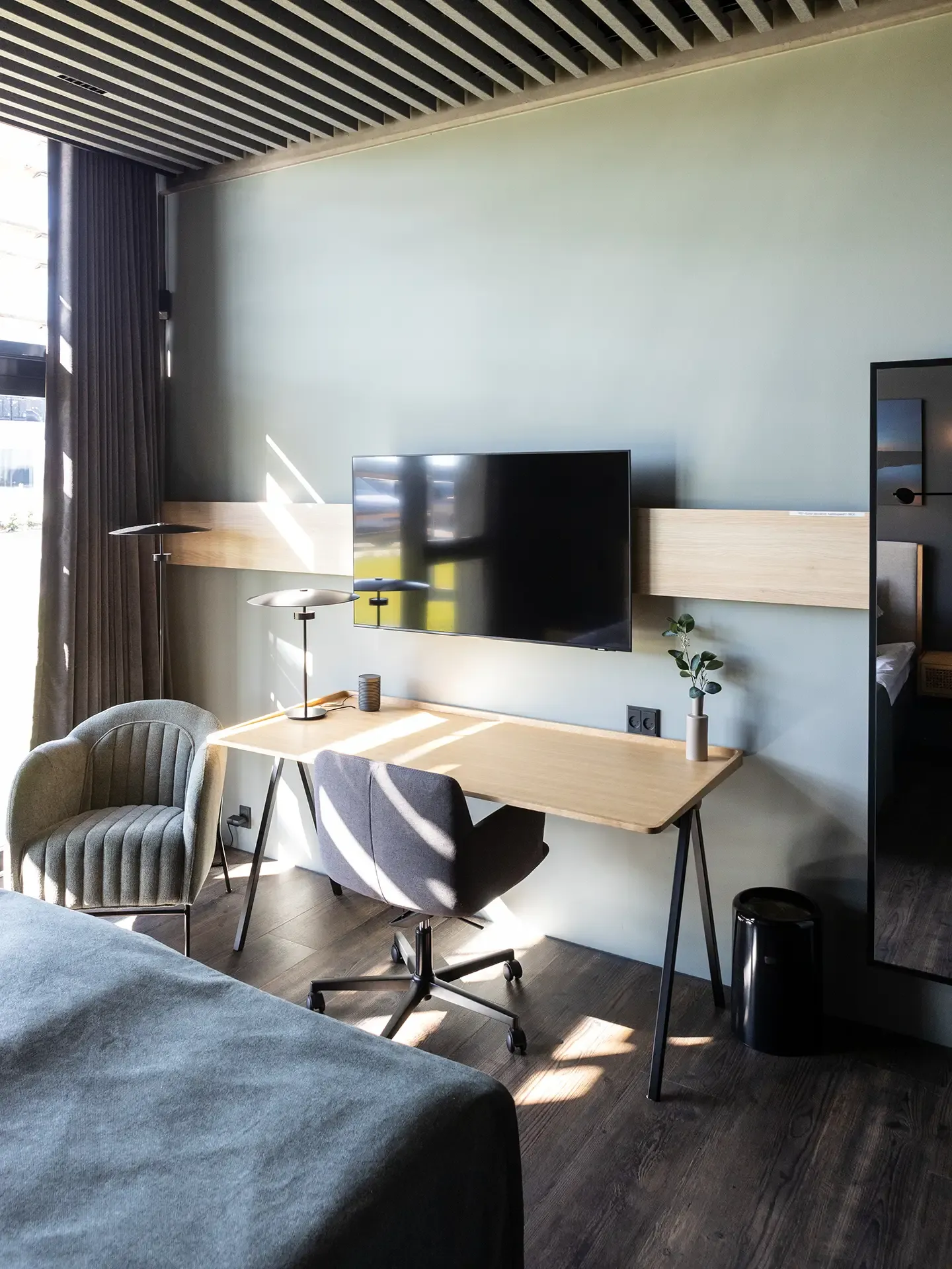 Private room for conference room with office desk. Light oak desk, large windows, and contemporary furniture.