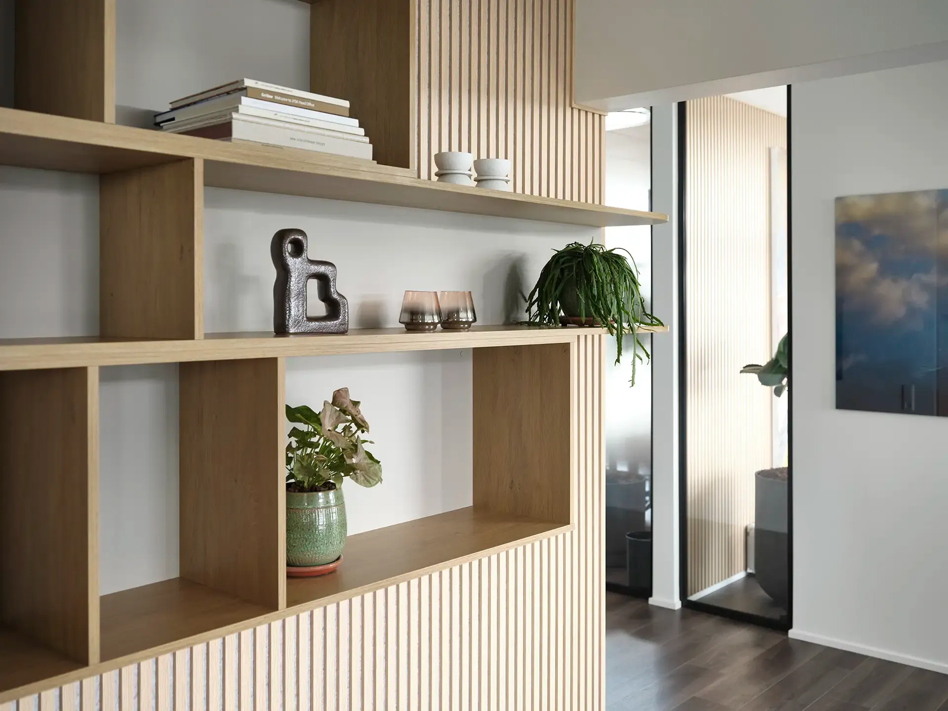 Custom-made office wall storage with wooden panels, blending functionality and contemporary corporate interior design.