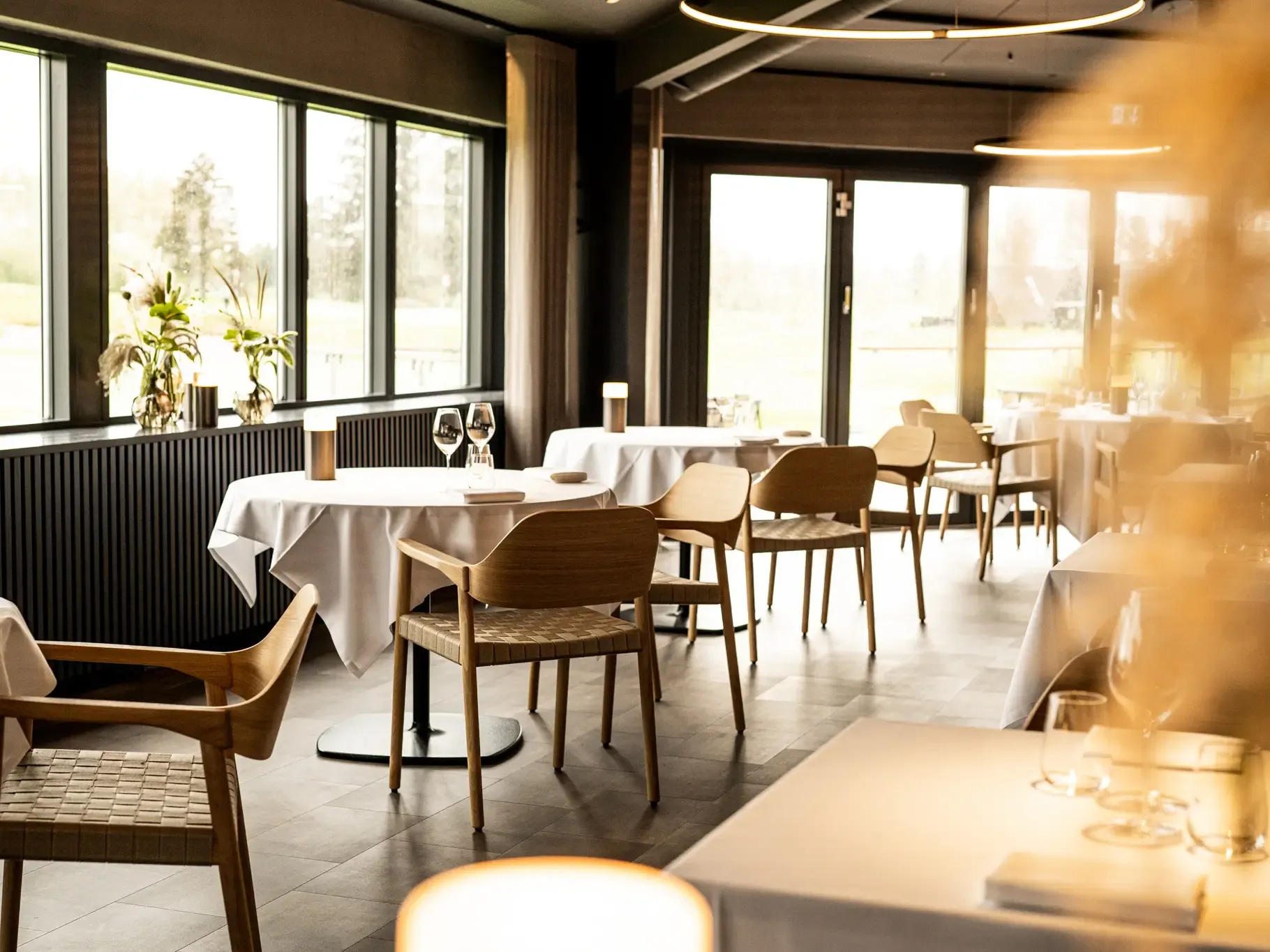 Fine dining interior design with light wood and intimate atmosphere at HimmerRiget.