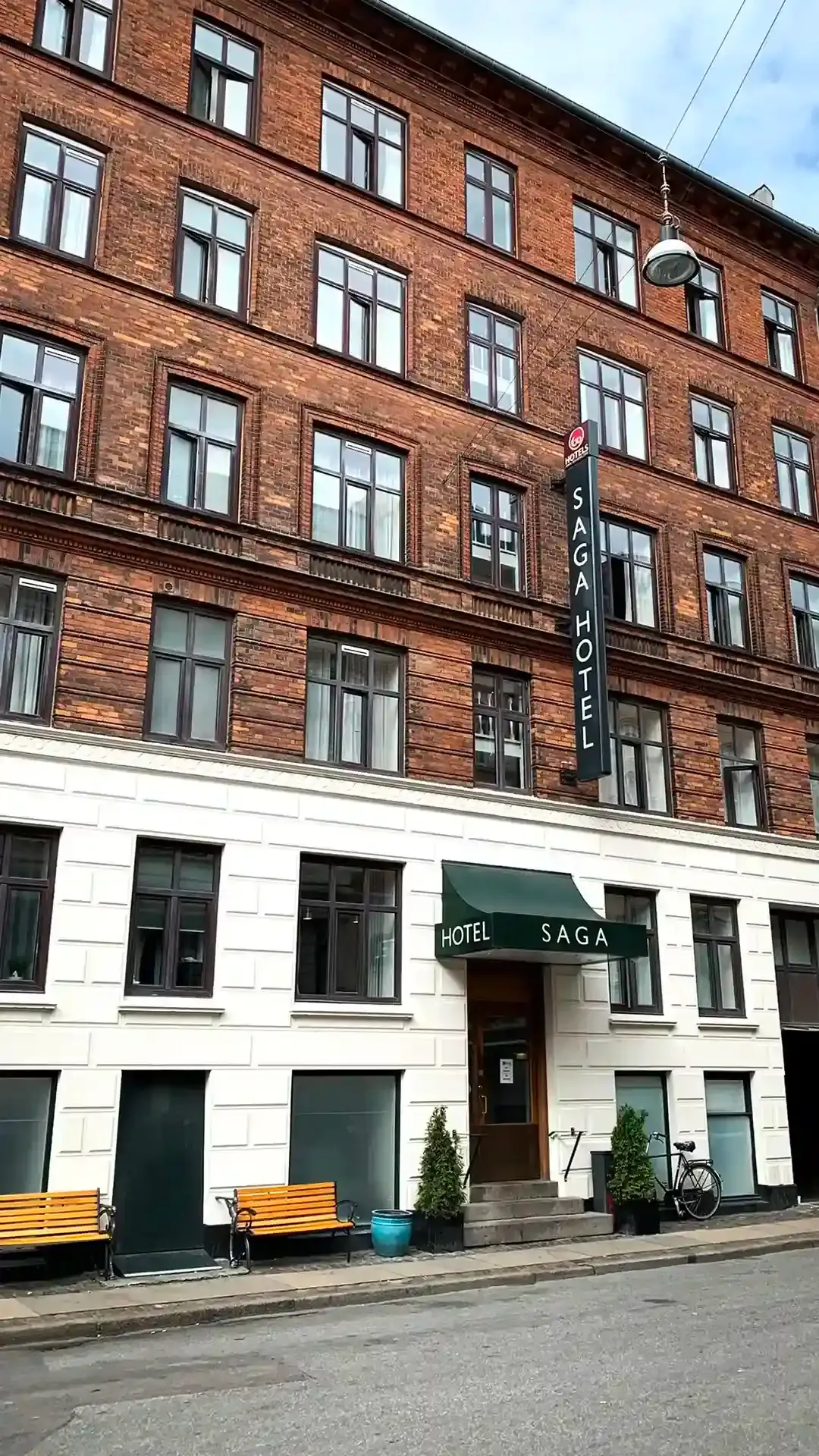 Facade view of Go Hotel Saga’s historic brick building in central Copenhagen.