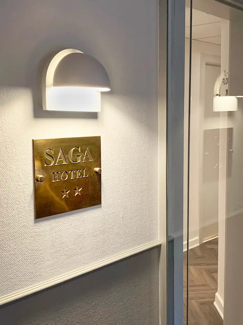 Brass plaque with Saga logo and two-star classification on hotel exterior.