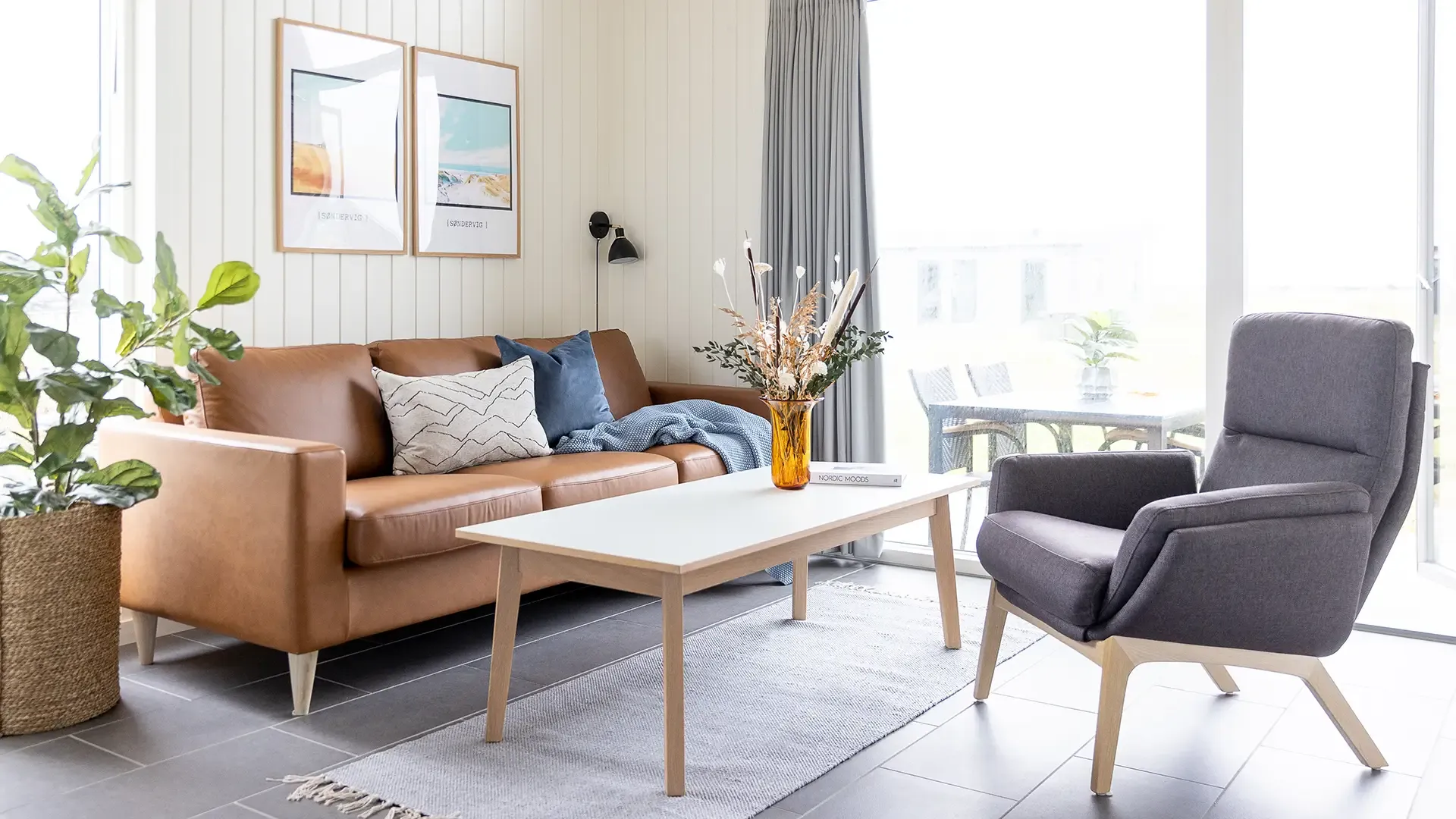 Living room in holiday cabin with cognac leather sofa – Lalandia, Søndervig interior style
