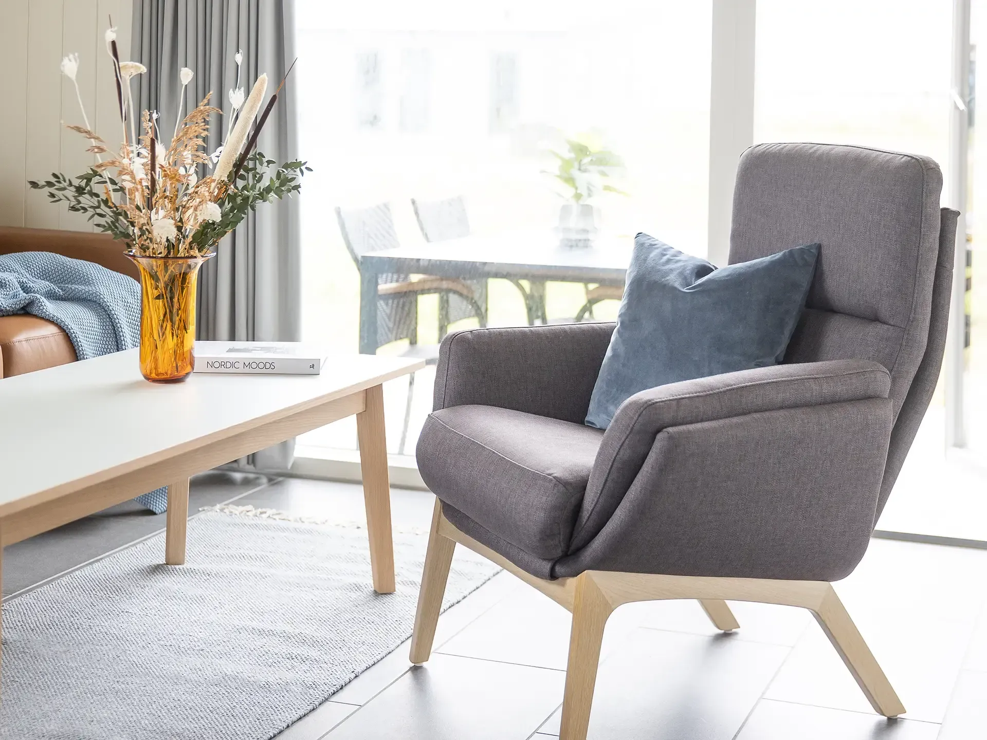 Grey fabric armchair in holiday cabin living room – Lalandia, Søndervig Nordic design