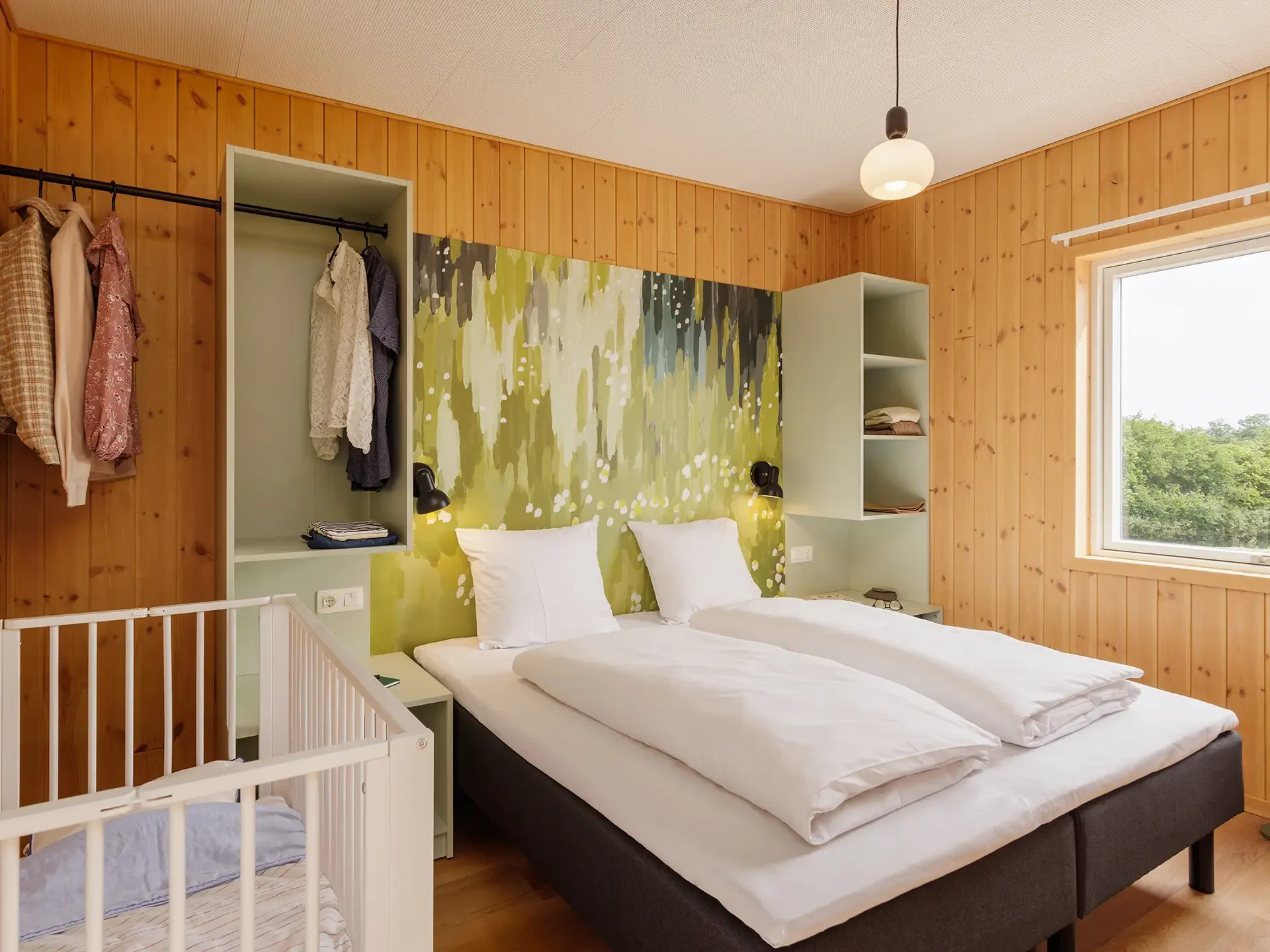 Bedroom with custom-built FF&E, integrated storage and graphic wall feature in a resort cottage at Nordborg Resort.
