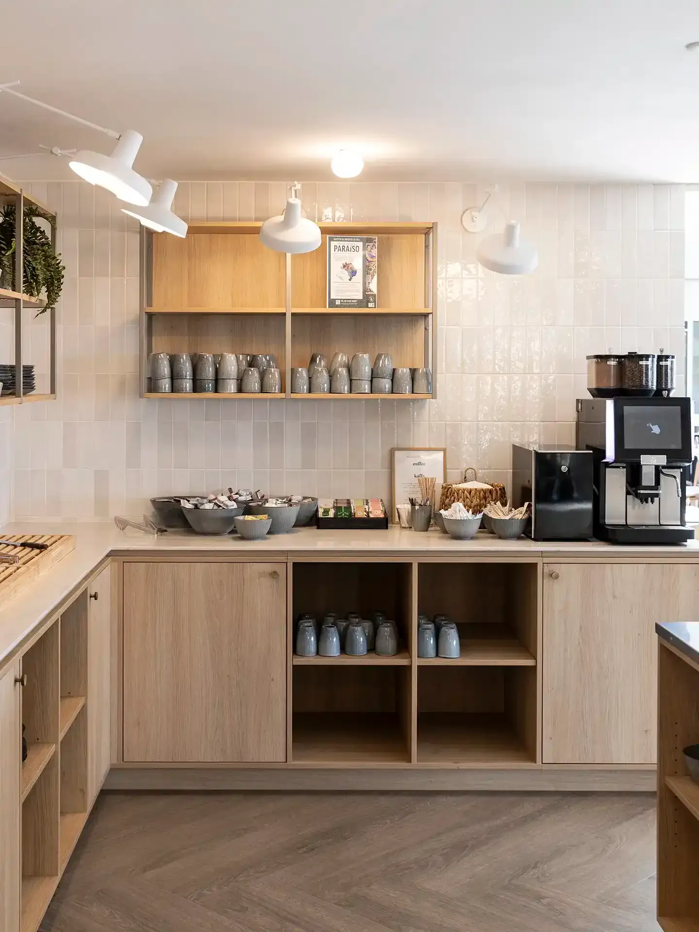Hotel breakfast bar with light wood interior and modern fixtures.