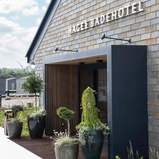 Hages Badehotel entrance with landscape design and natural materials.
