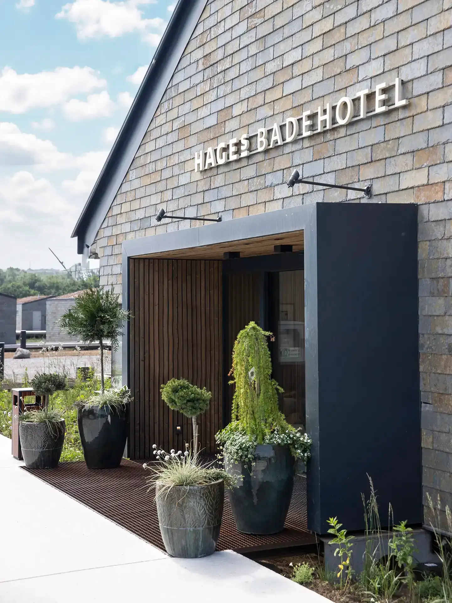 Hages Badehotel entrance with landscape design and natural materials.