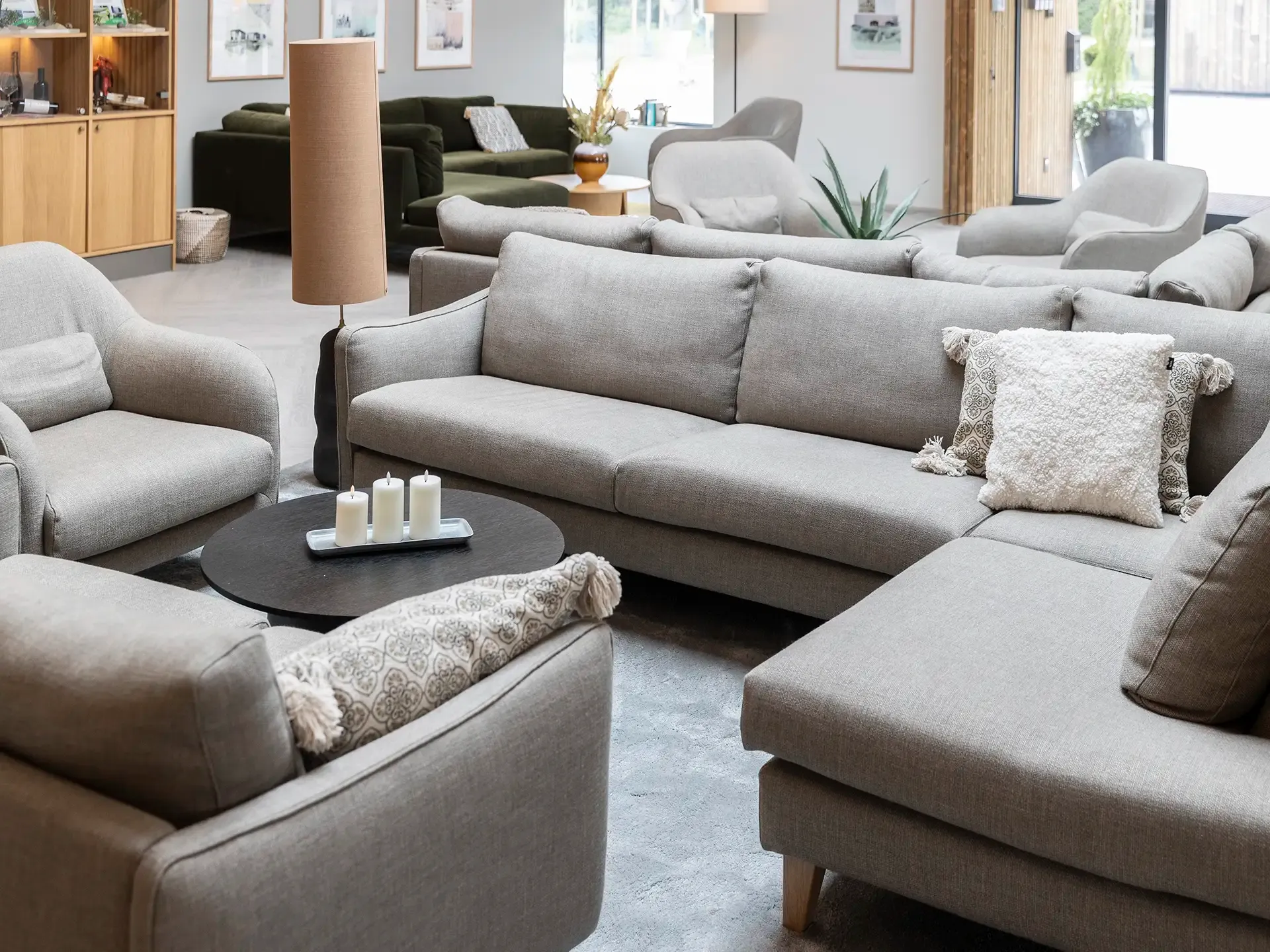 Spacious hotel lounge with multiple sofas arranged for guest relaxation.