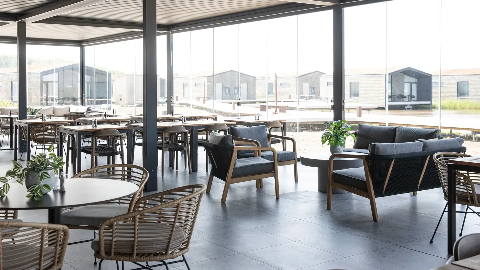 Open-plan hotel restaurant design with mixed seating arrangements.