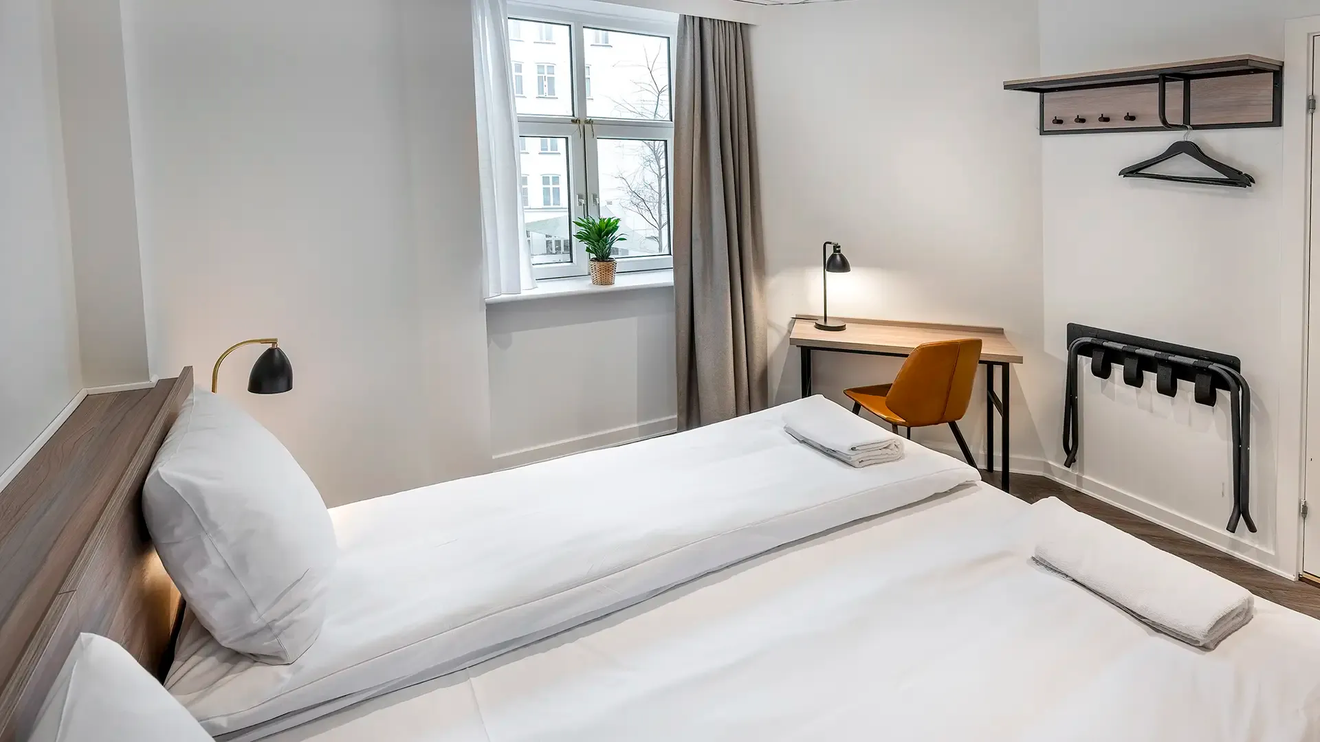 Modern Nordic-style hotel room with white tones and custom furniture from Third.space.
