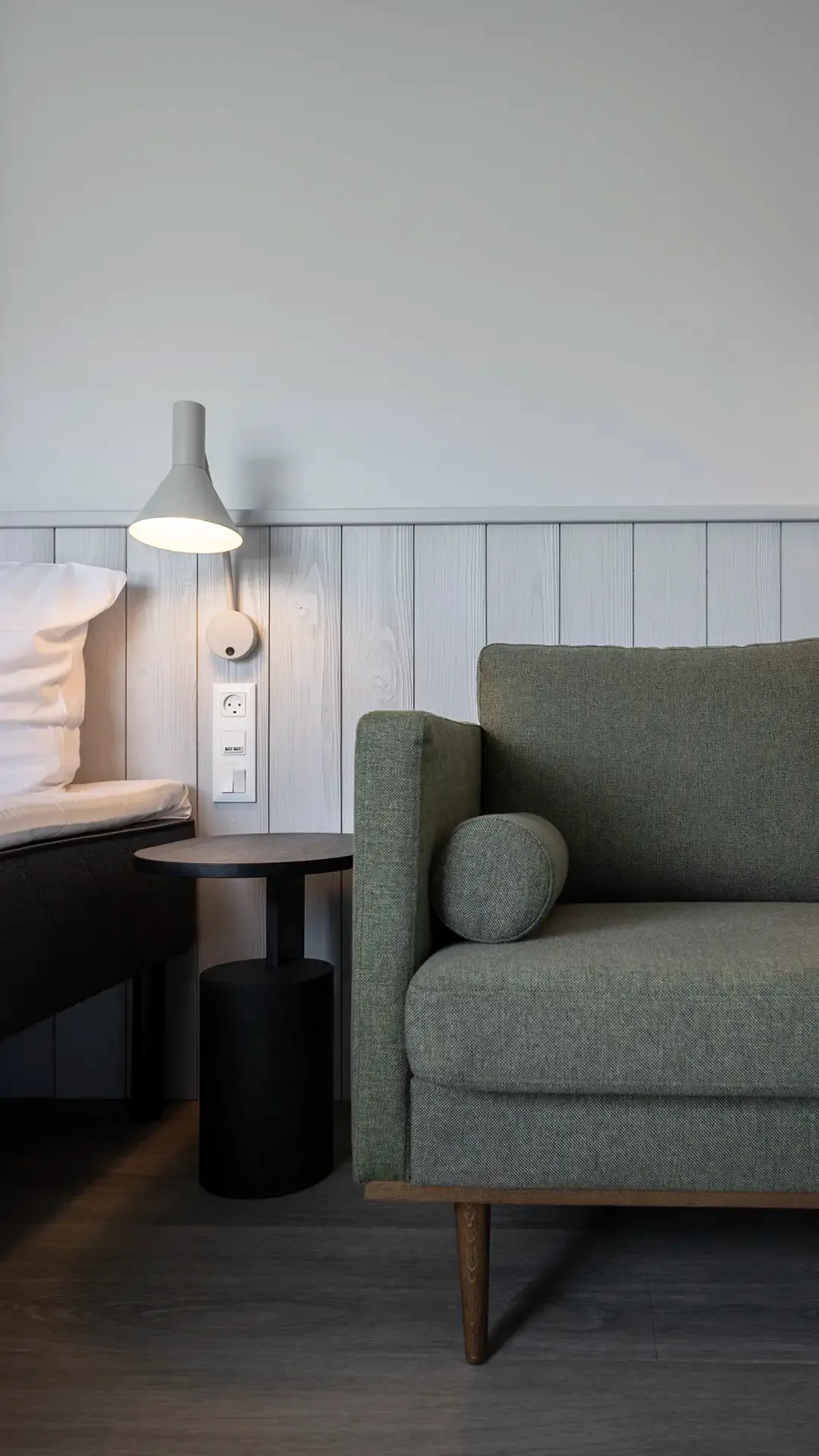 Hotel room seating area with green fabric sofa. Nordic design by Third.space.