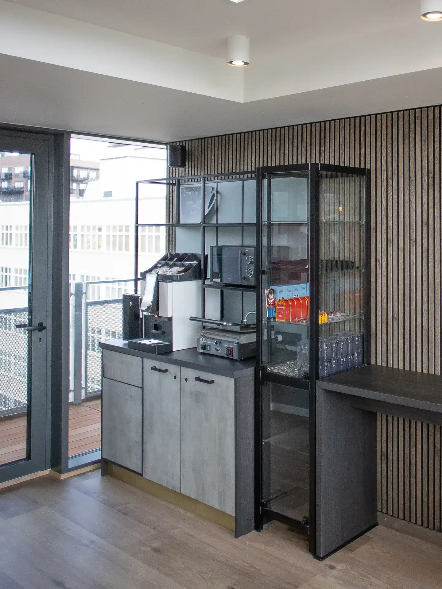 Coffee station and storage unit in modern hotel interior.