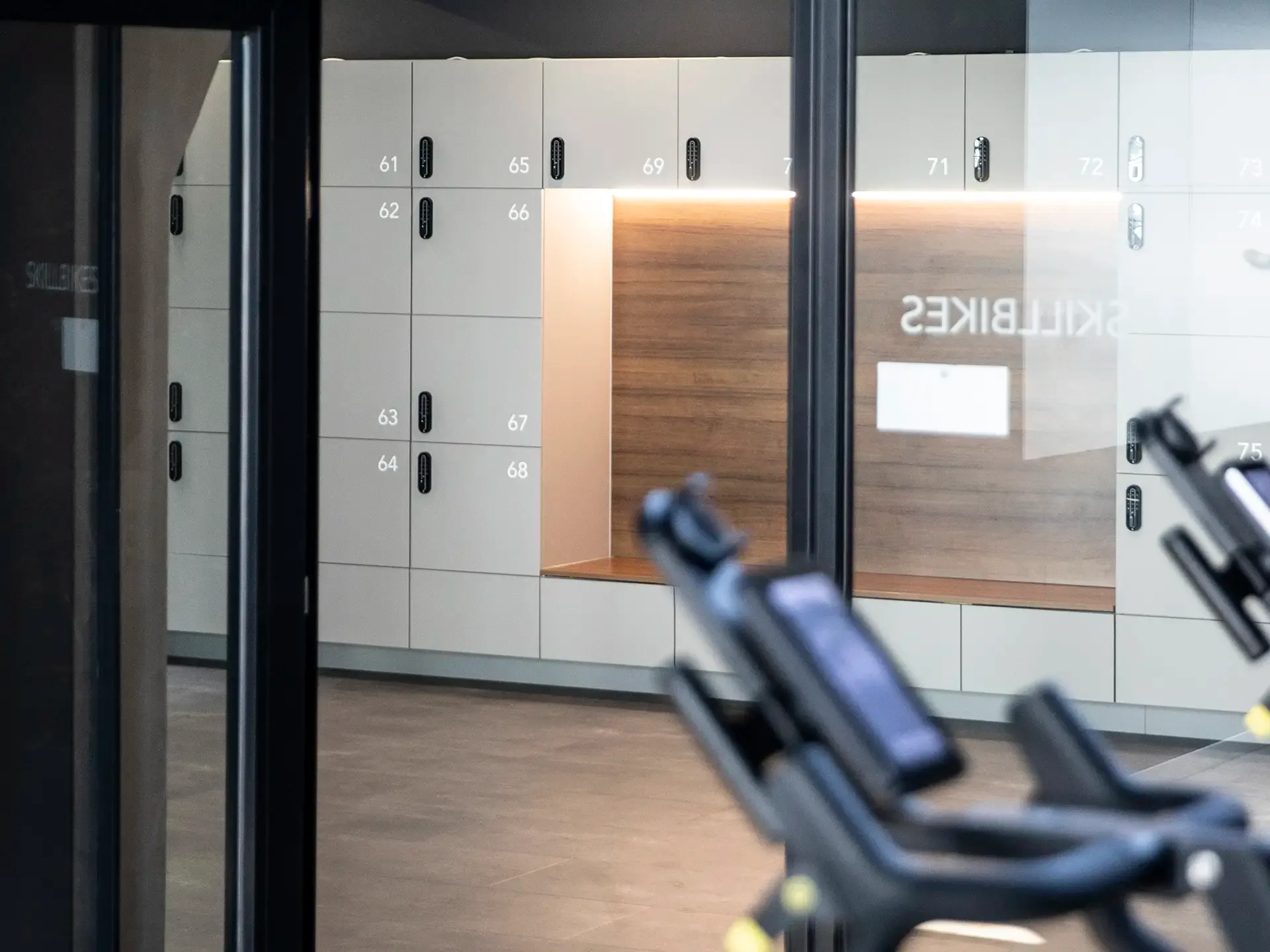 Bespoke locker system with integrated seating in light oak — designed by Third.space for modern Nordic interior environments.