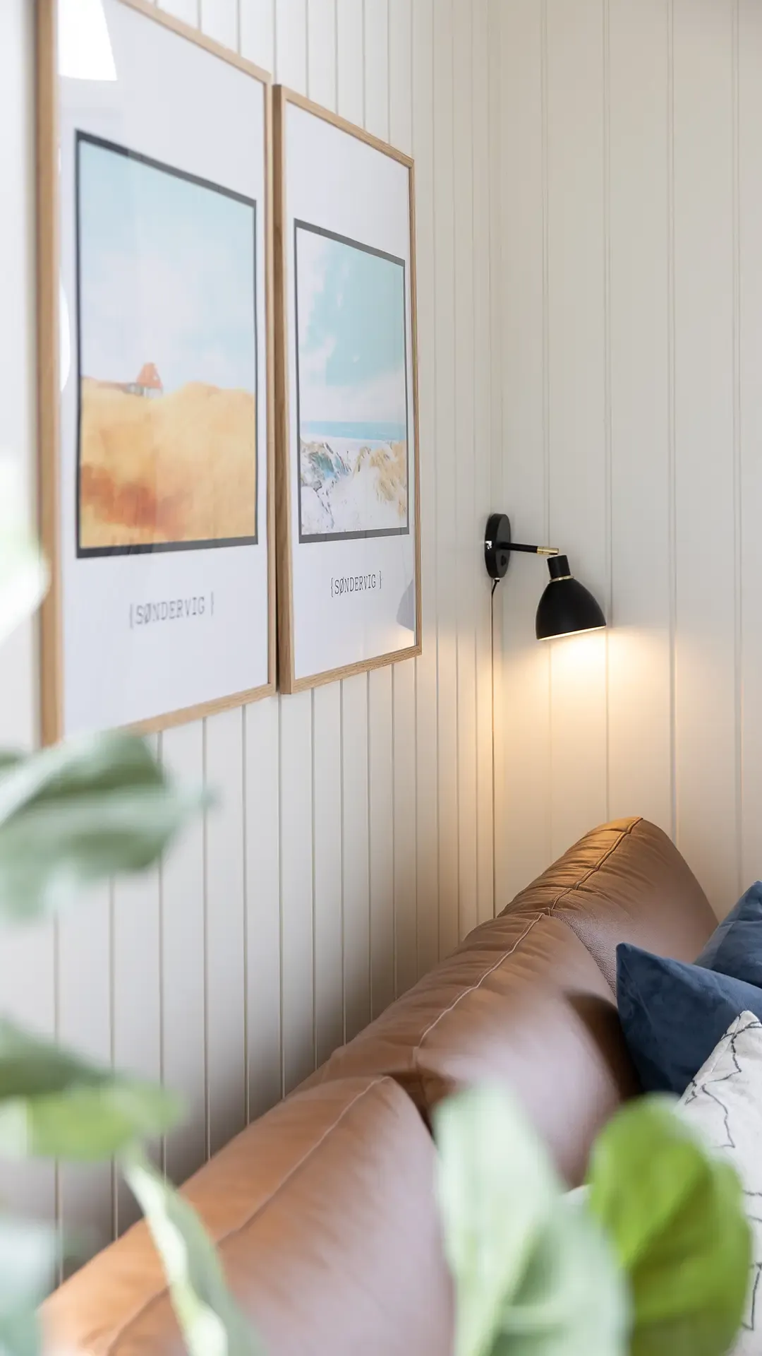 White profile wall boards and Søndervig beach posters in holiday home
