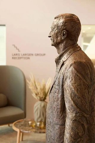 Bronze sculpture of Lars Larsen displayed in corporate head office, reflecting heritage and company history.