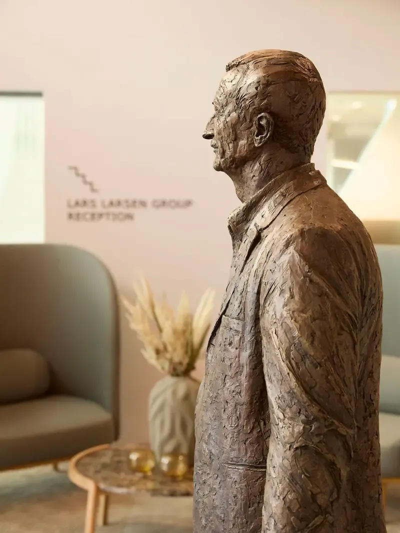 Bronze sculpture of Lars Larsen displayed in corporate head office, reflecting heritage and company history.