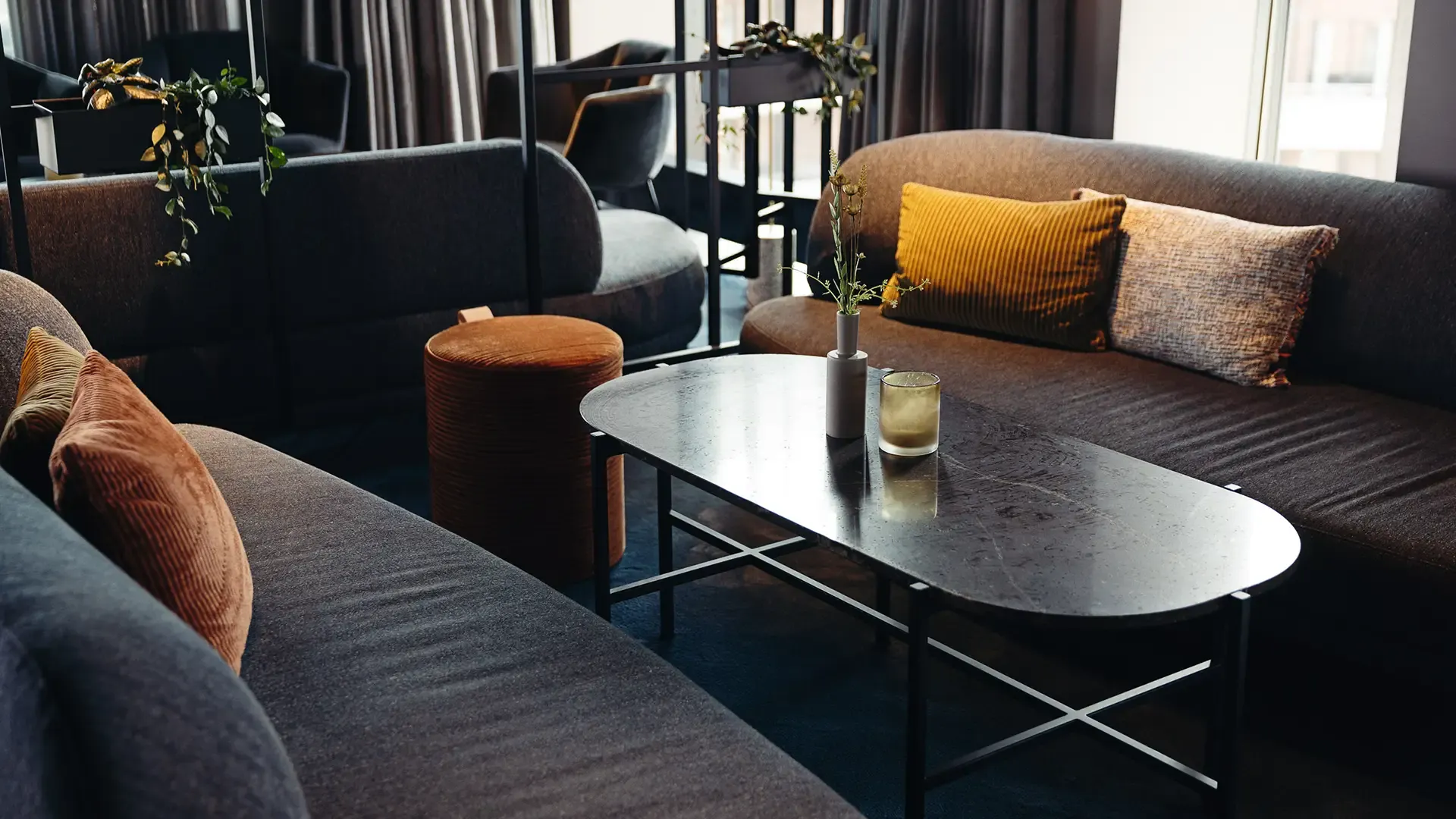 Cocktail bar lounge with dark-toned furniture and rich textiles, designed for luxurious and intimate guest experiences.