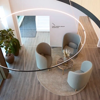 Office entrance with Bolia lounge chairs and corporate branding, creating a professional and welcoming impression for visitors.