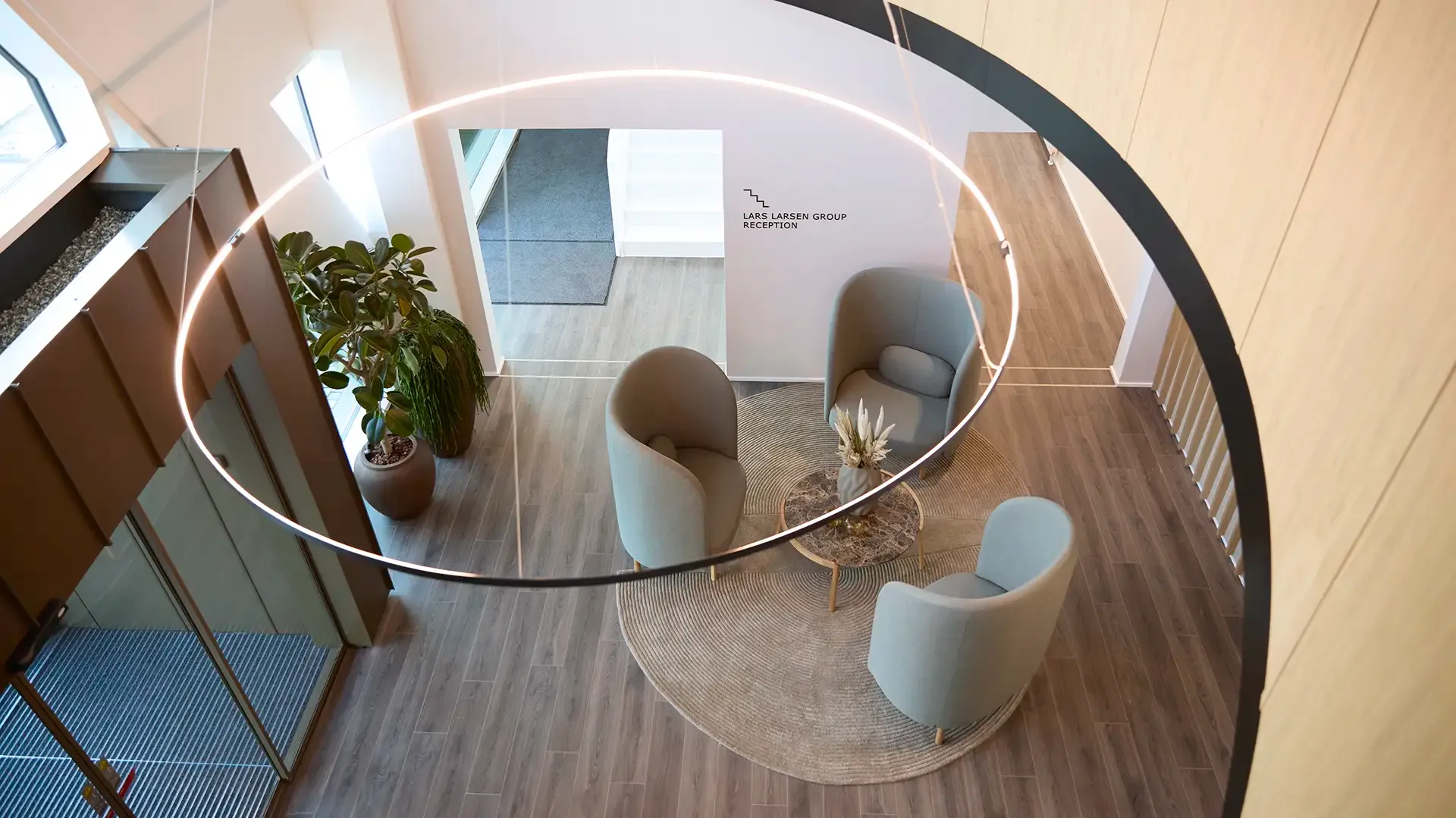 Office entrance with Bolia lounge chairs and corporate branding, creating a professional and welcoming impression for visitors.