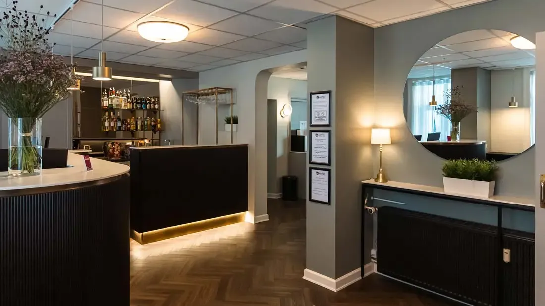 Go Hotel Saga reception and bar area designed by Third.space, blending wood, brass, and welcoming light.