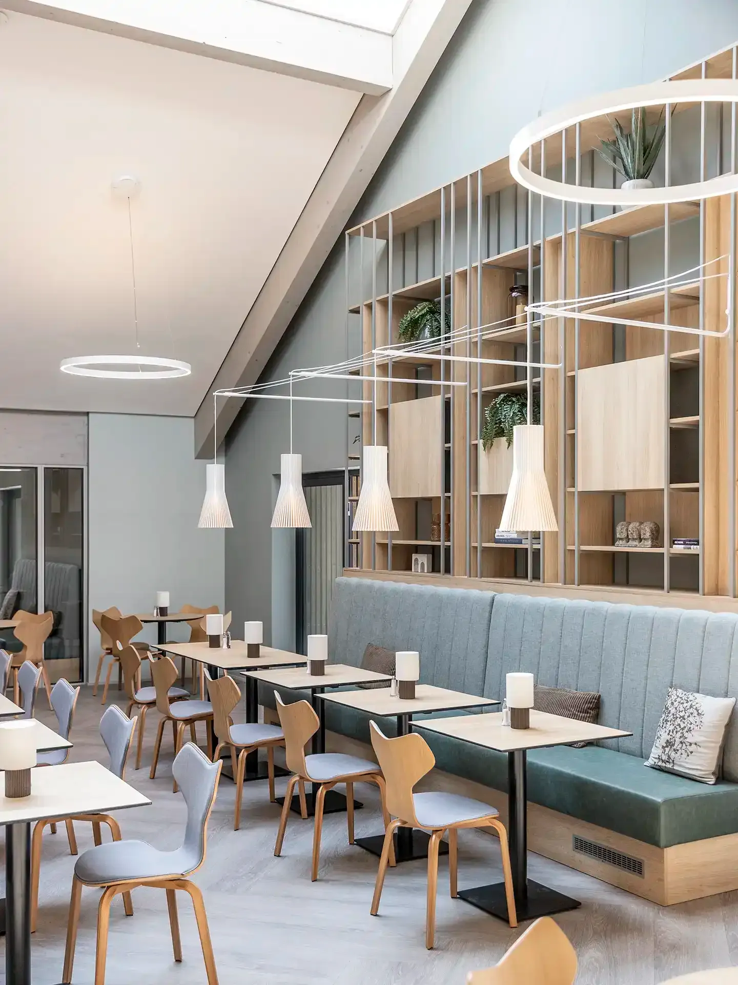 Custom seating in Scandinavian-style hotel breakfast restaurant.