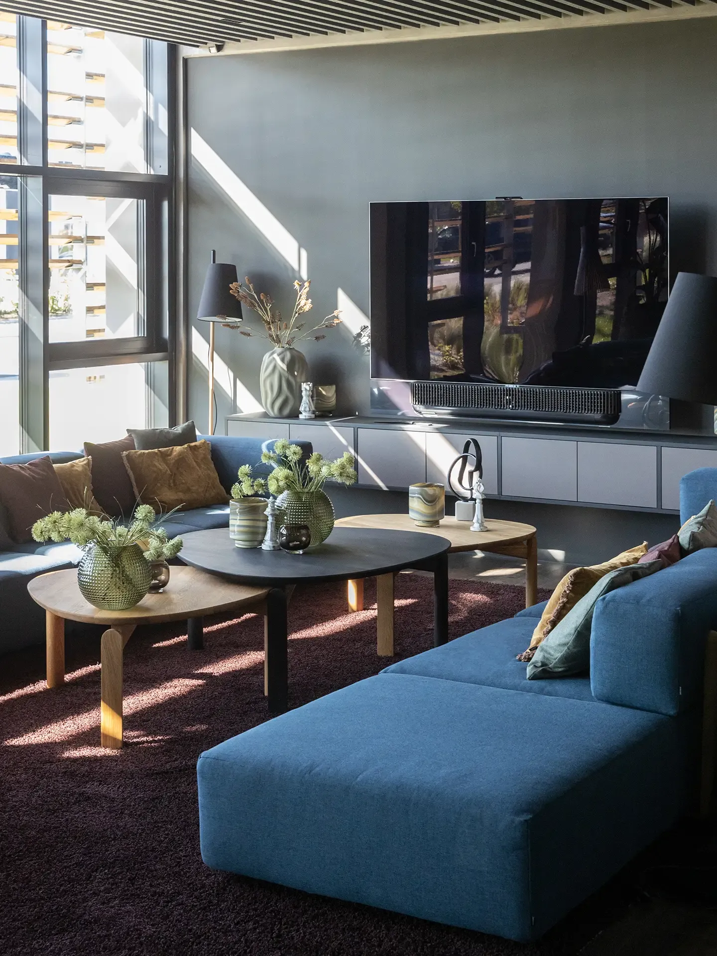 Conference room lounge area featuring Bolia sofas and accent tables in an exclusive showroom design.
