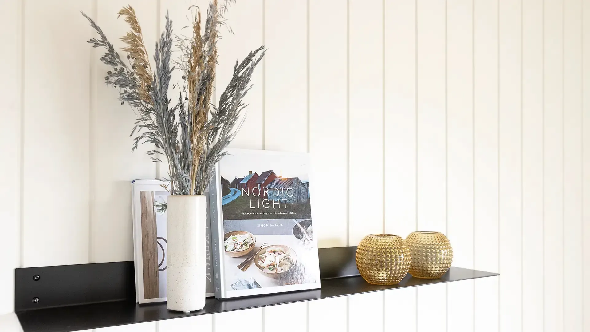 Decorative shelf with styled objects in holiday home interior design