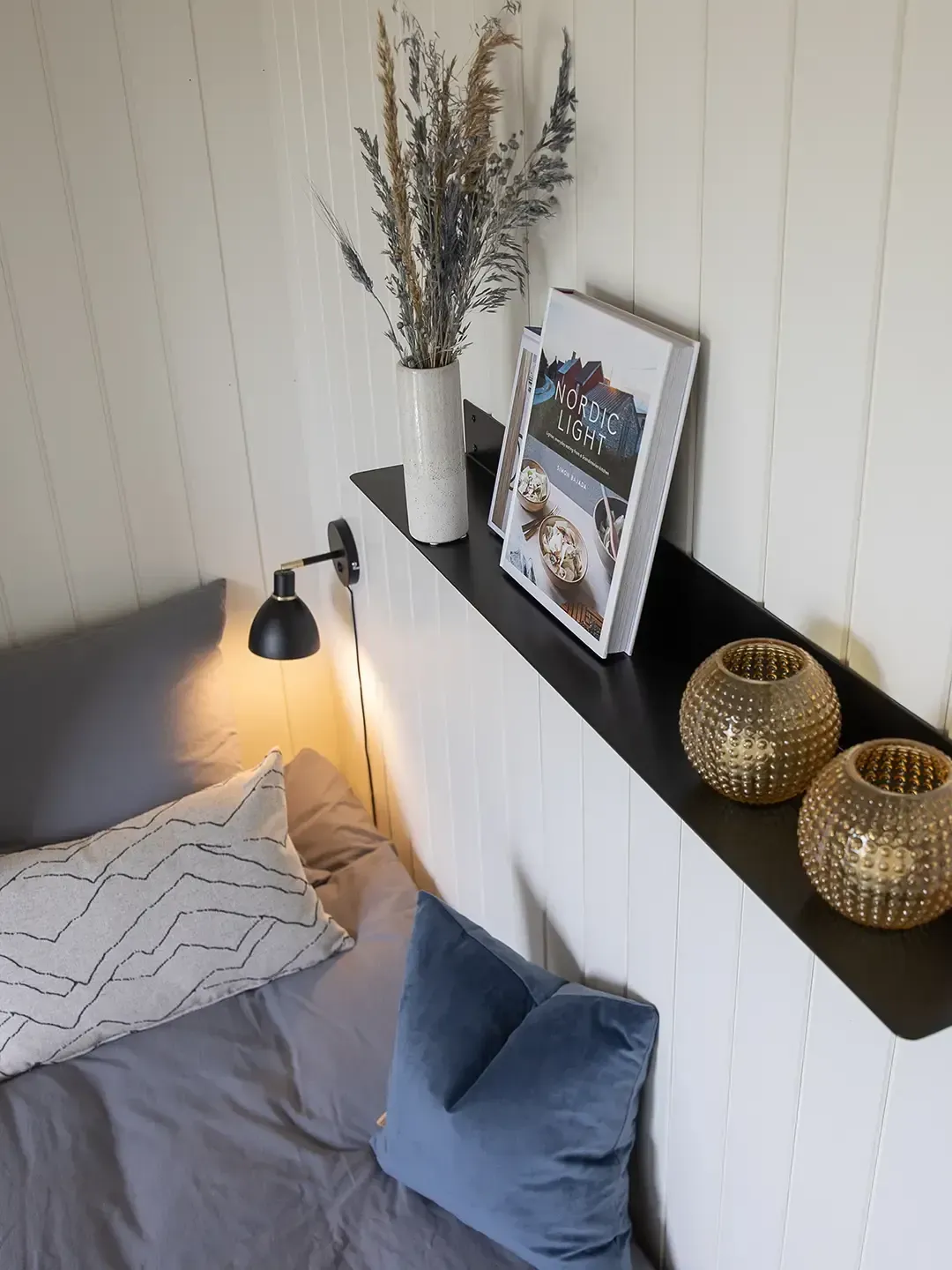 Shelf with home decor elements in holiday cottage interior