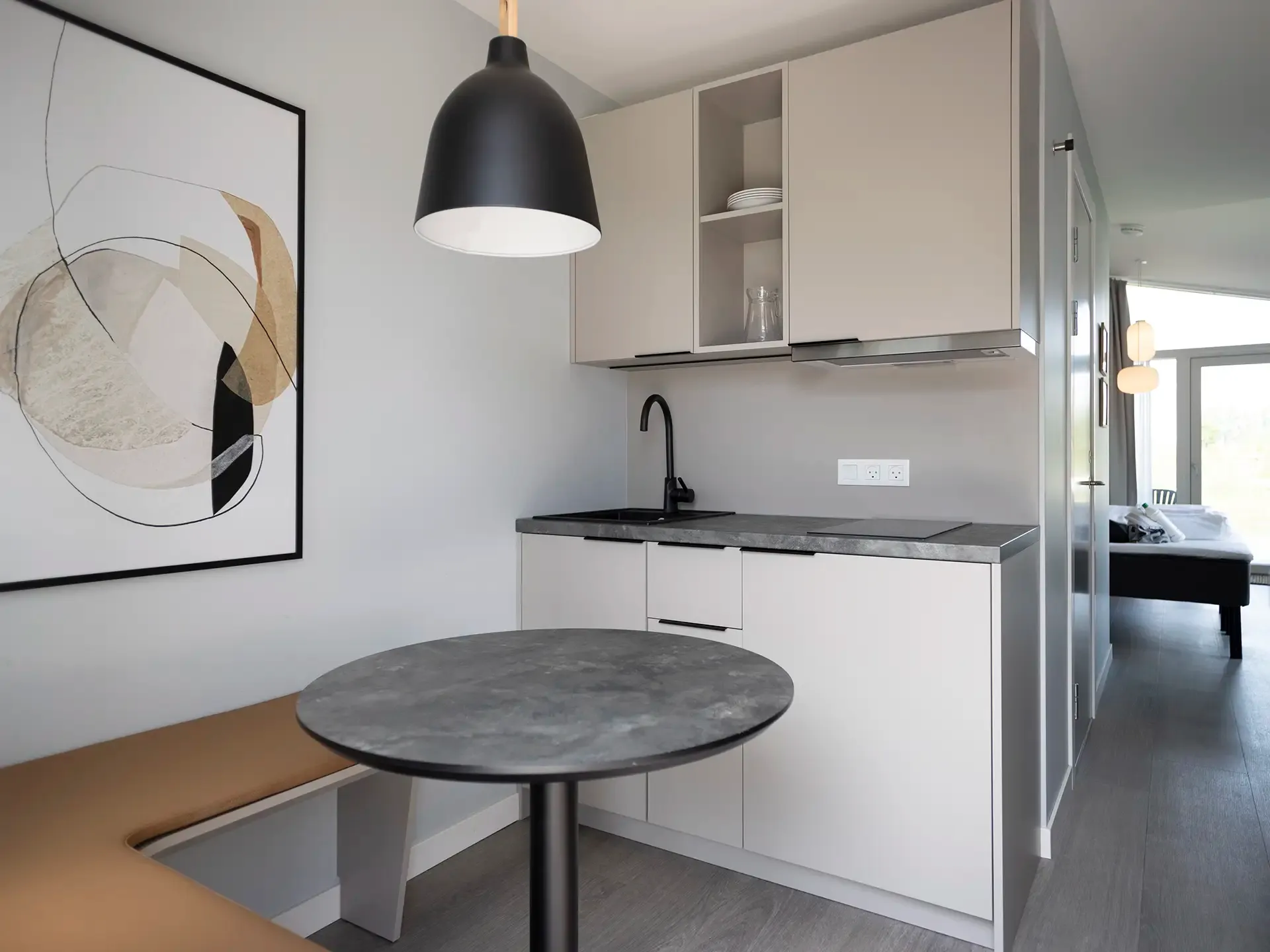 Small hotel apartment with kitchen and dining area for long-term rental.