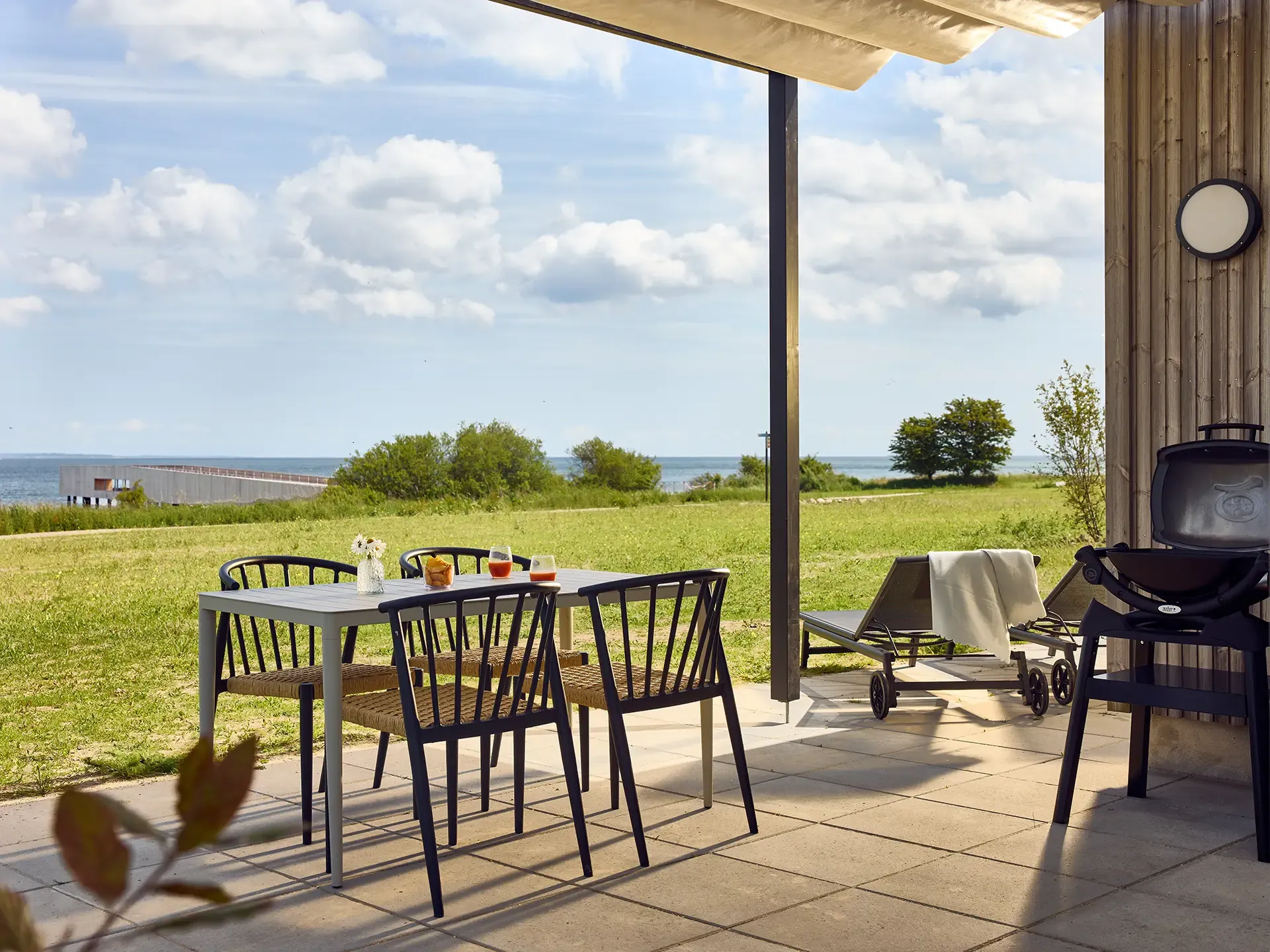 Durable outdoor dining furniture specified for a resort terrace environment with landscape views at Nordborg Resort.