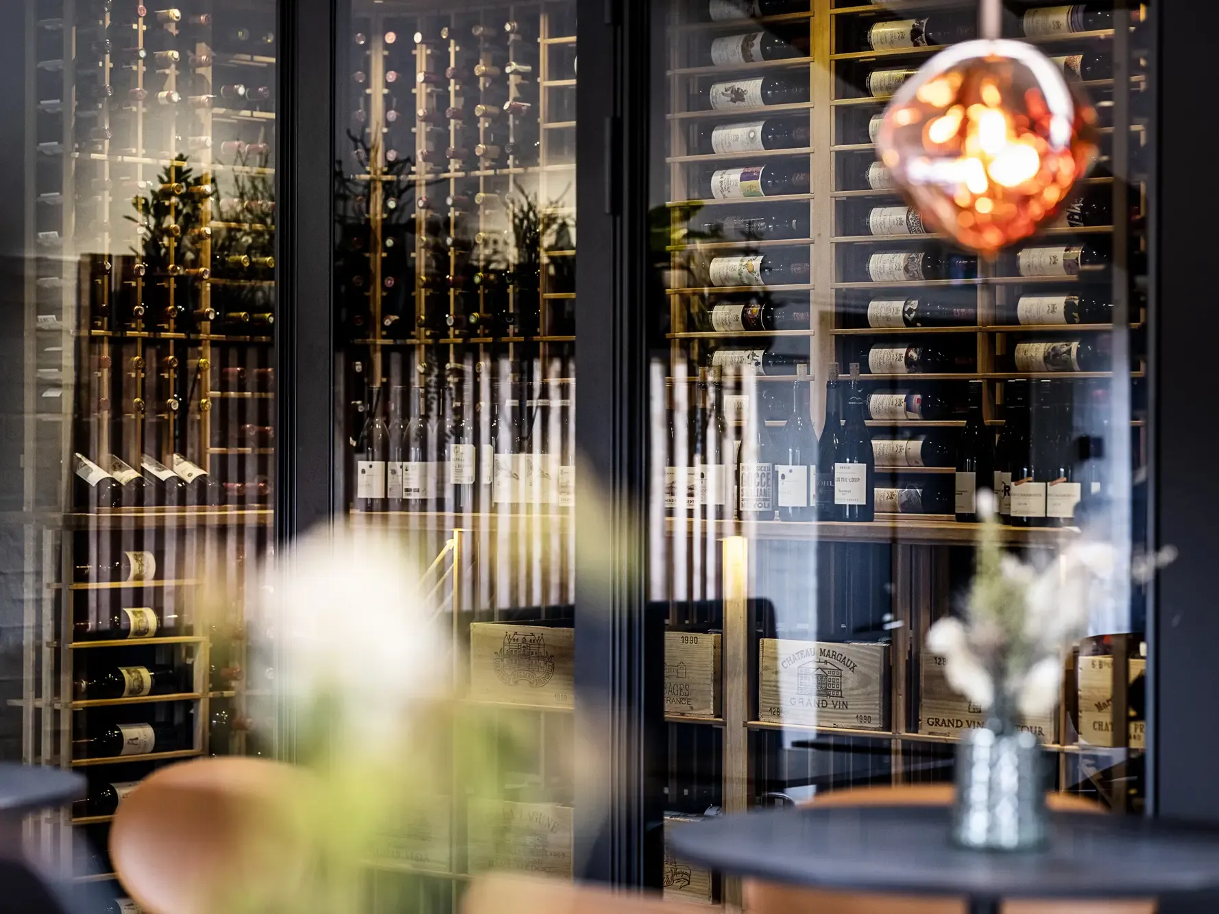 Wine storage and visual display with glass doors and beautiful lighting.