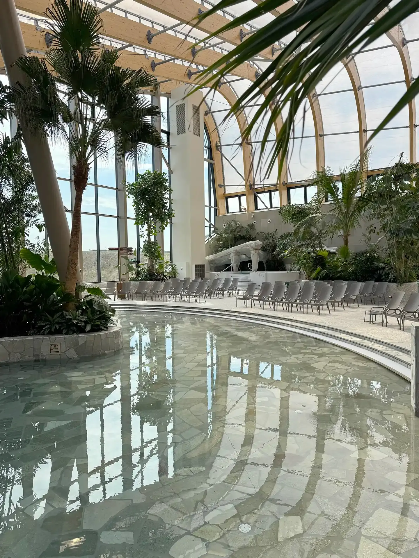 Interior of the Aqua Dome at Nordborg Resort with tropical greenery, pool area and durable chlorine-resistant furniture.