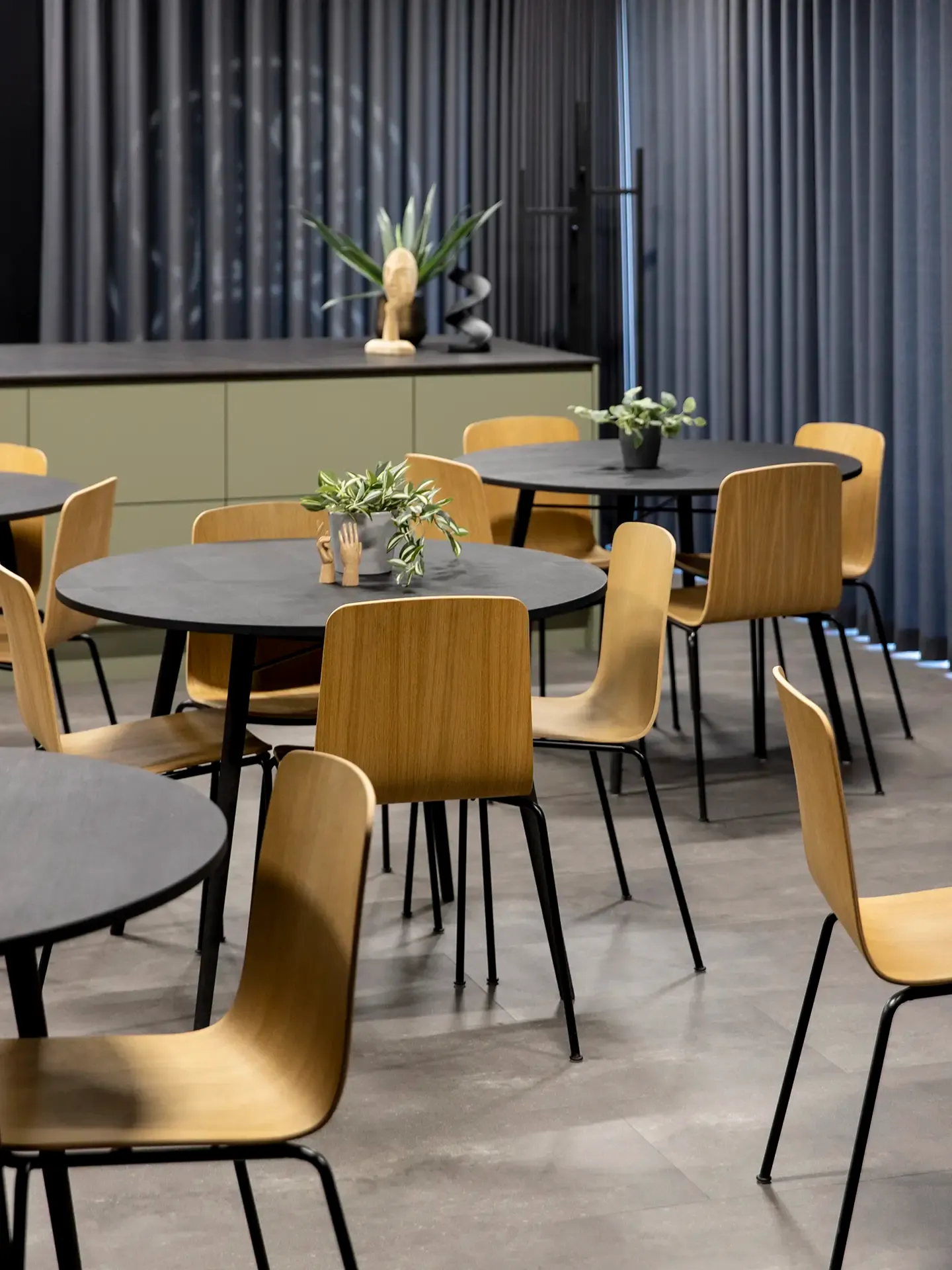 Functional dining area with wooden chairs and durable round tables, ideal for sport clubs needing stylish and robust communal seating.