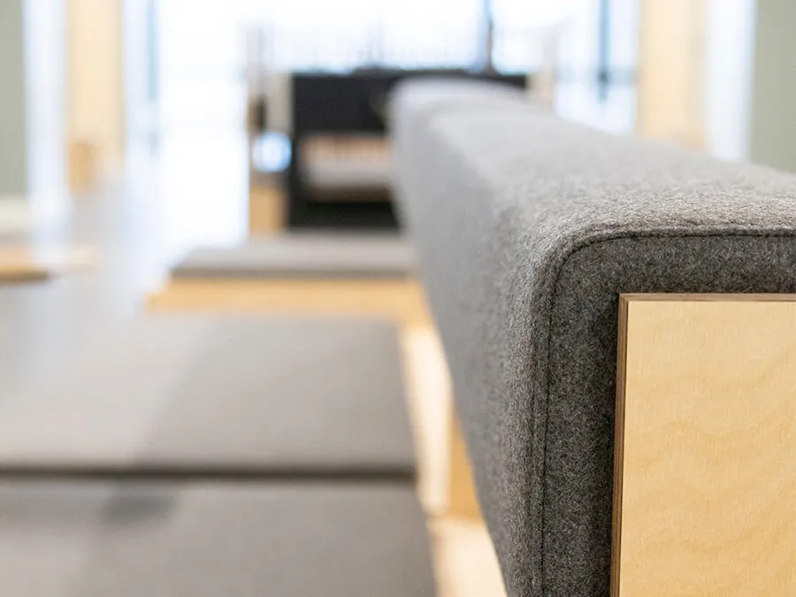 Close-up of upholstered bench backrest detail showcasing premium craftsmanship in bespoke furniture for student housing.