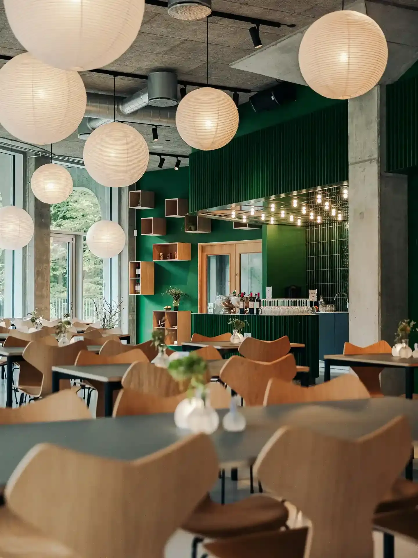Stylish restaurant seating with Danish wooden chairs from Fritz Hansen, offering ergonomic comfort and classic aesthetics for high-traffic hospitality environments.