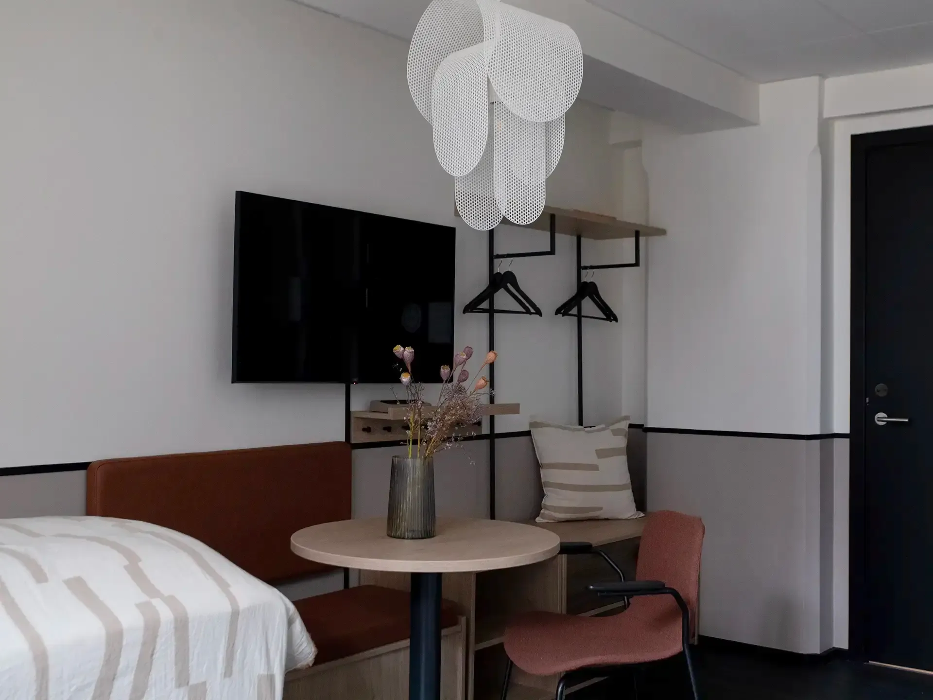 Fully furnished small apartment with bespoke furniture and dining area, tailored for efficient short-term hospitality solutions.