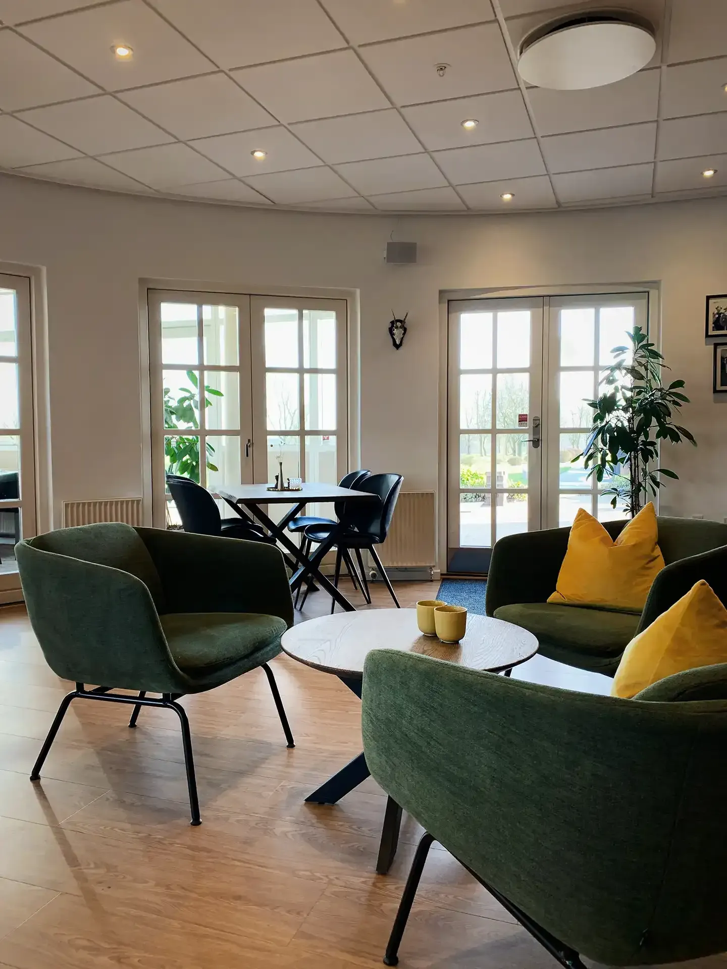 Lounge area with green fabric chairs in a golf clubhouse
