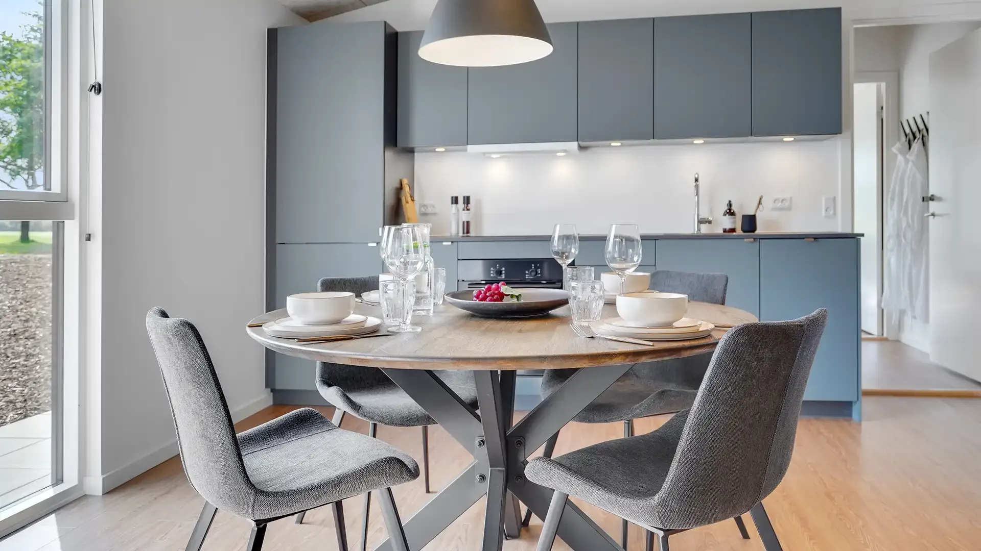 Grey dining chairs and wooden table in golf lodge