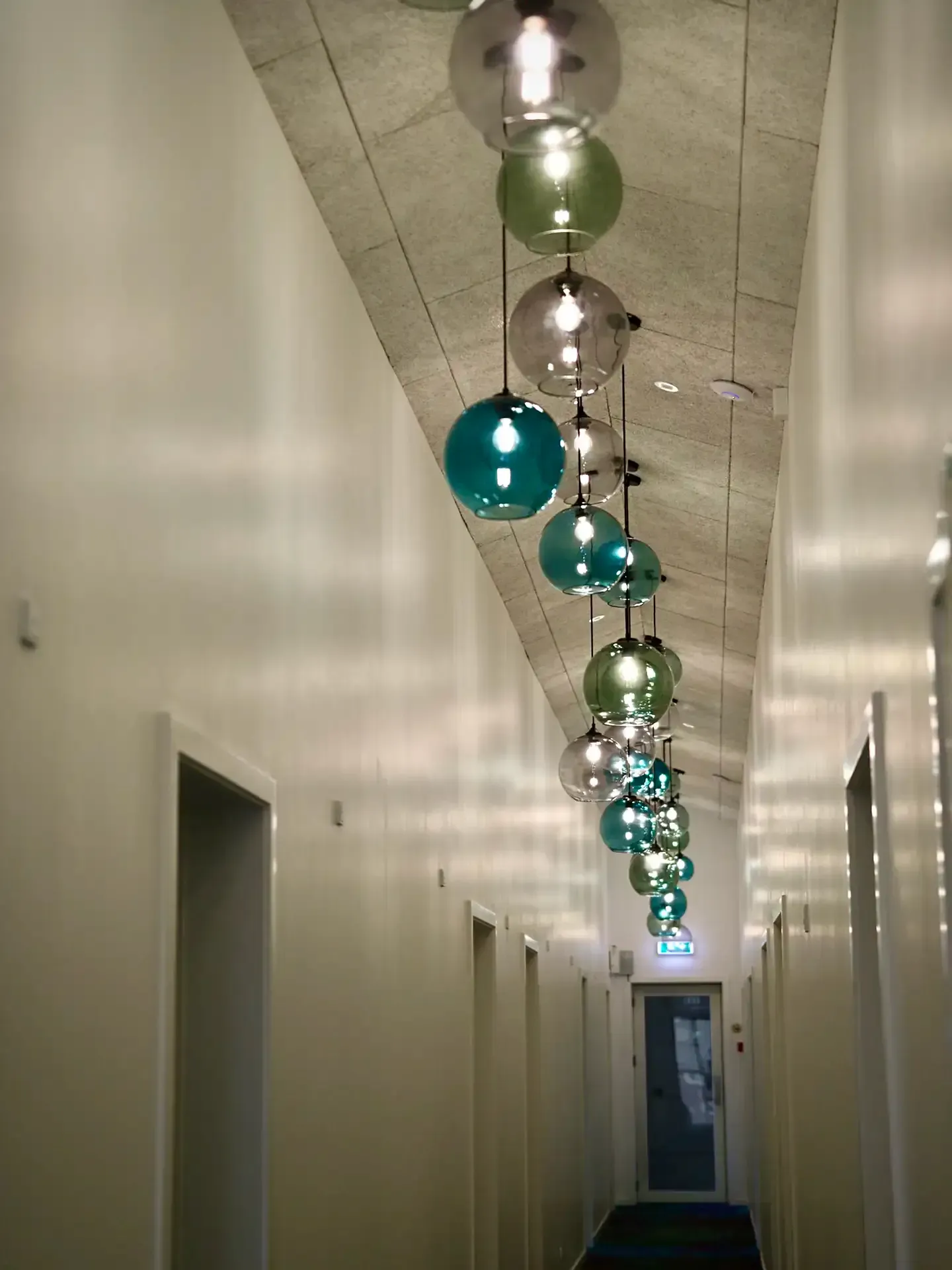 Hotel corridor designed by Third.space with decorative glass lighting inspired by the Northern Lights