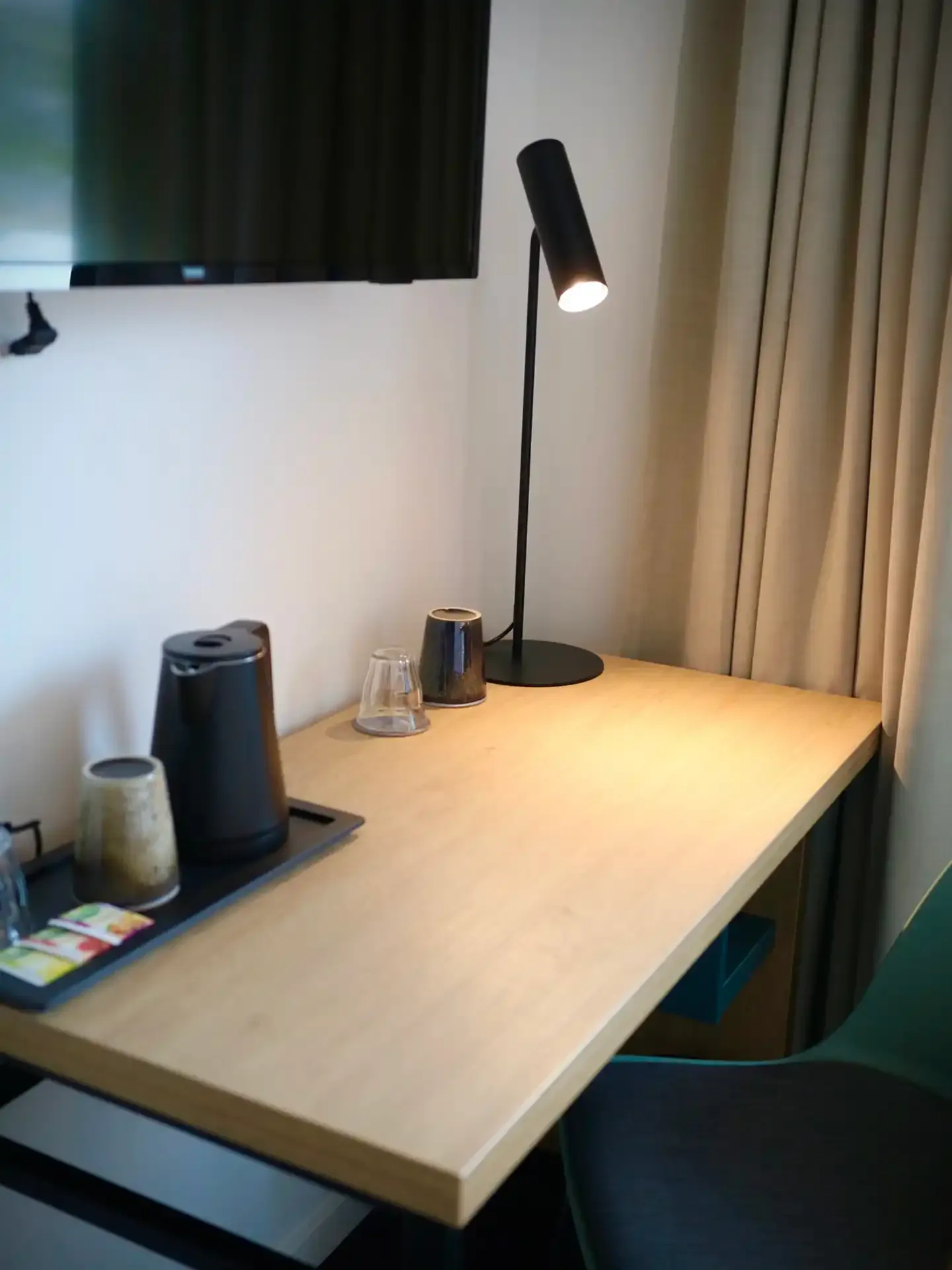Custom hotel desk in oak with black metal lamp and beverage tray, designed by Third.space for compact guest rooms