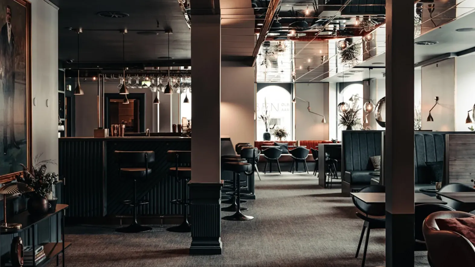 Full view of luxury restaurant interior with bar, dining areas, and custom furnishings at Richards Bar, Hotel Royal.