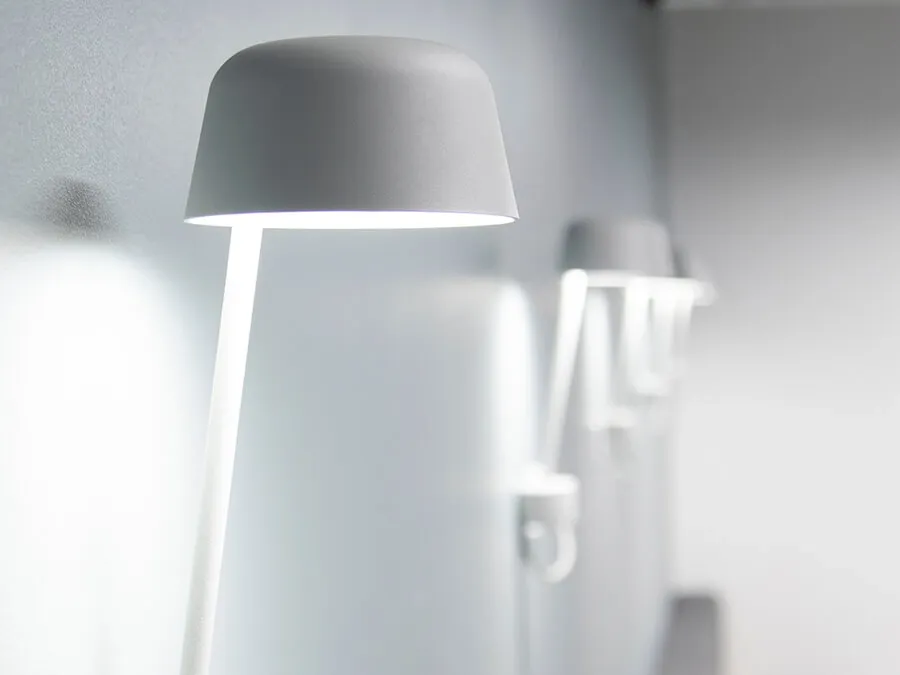 Minimalist wall-mounted light fixture in matte white, designed as part of bespoke interior solutions.