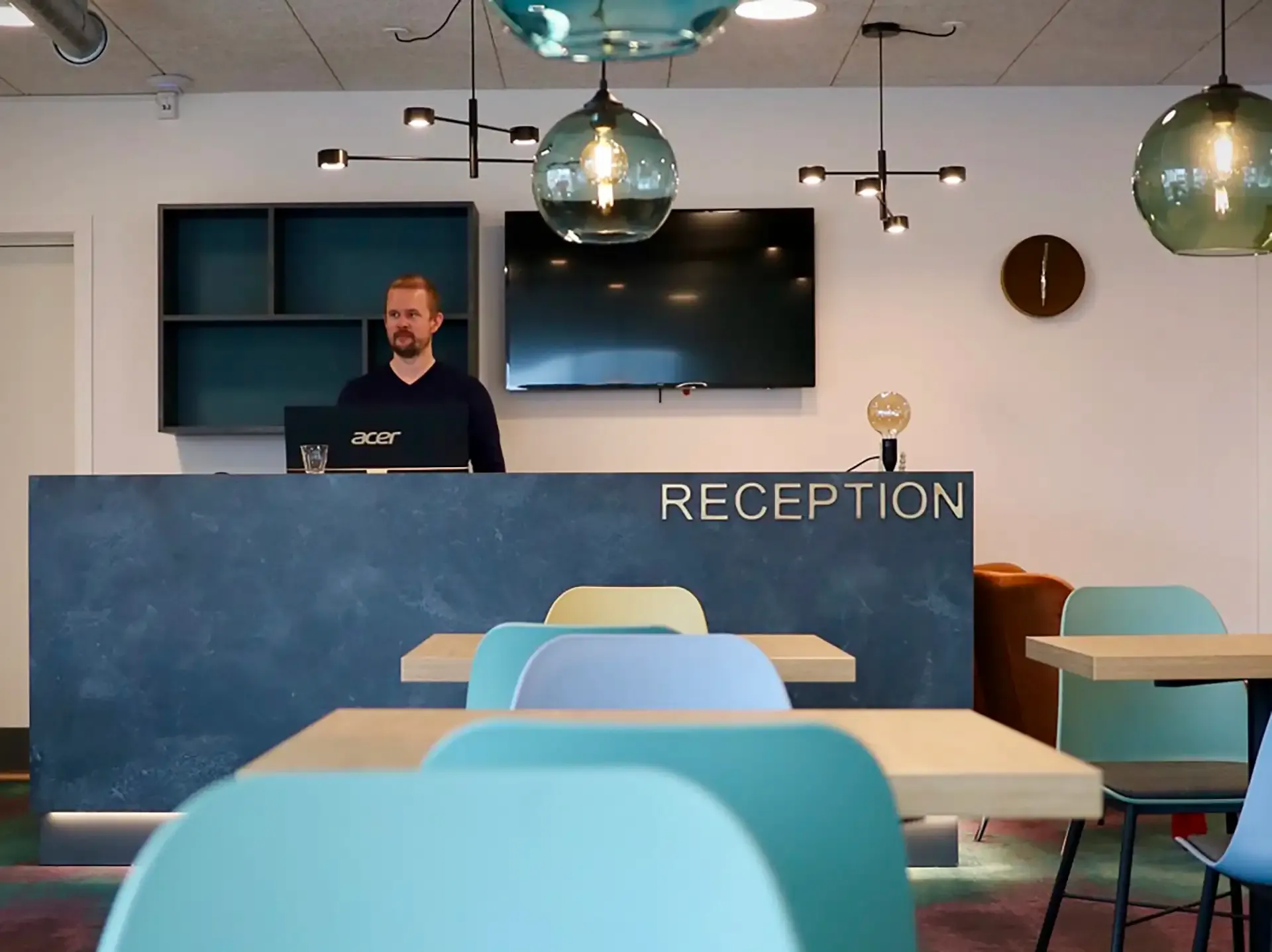 Hotel reception designed by Third.space featuring custom desk, integrated lighting and brand-aligned furniture