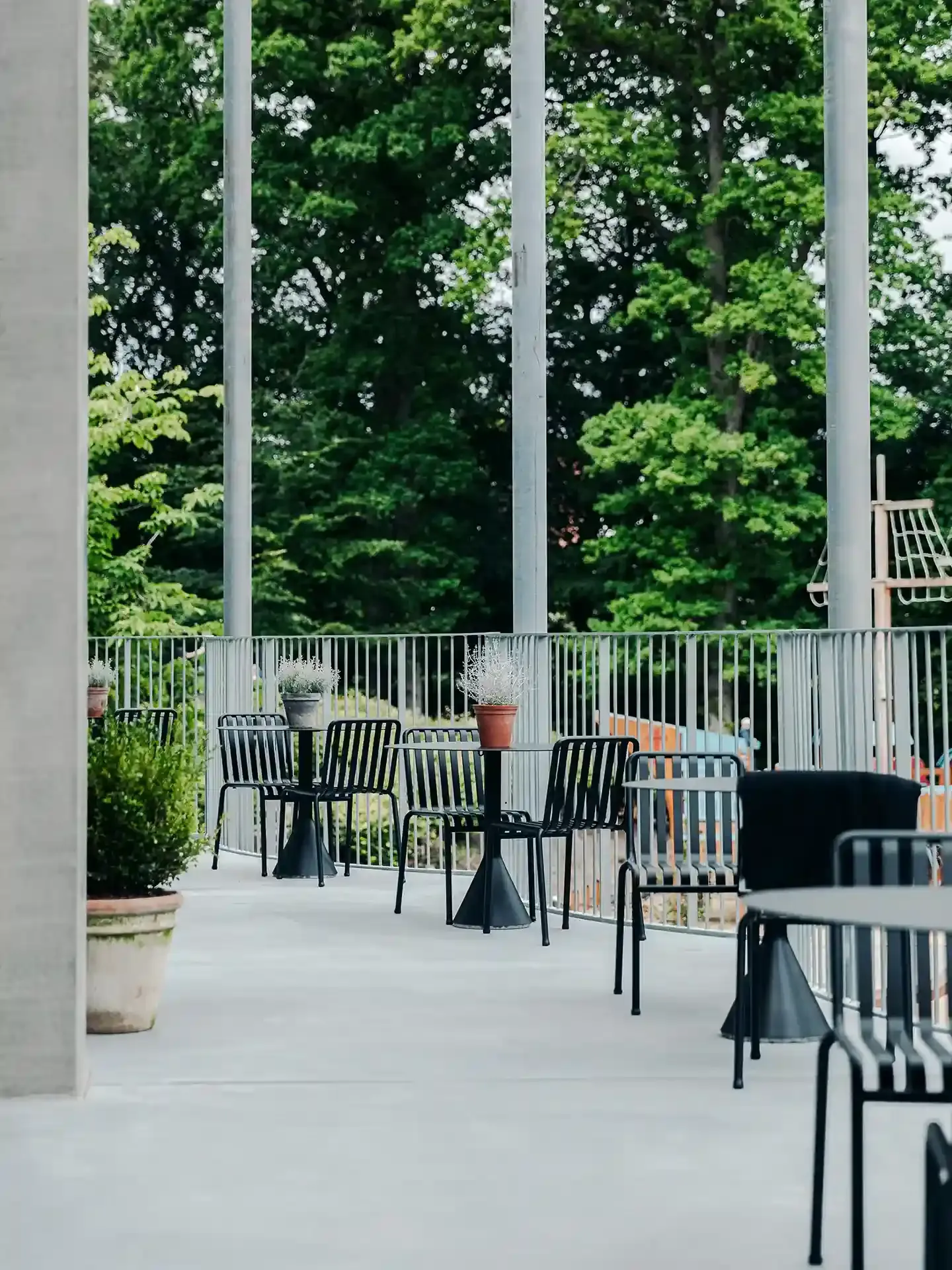 Chic outdoor restaurant terrace with black powder-coated metal furniture, built for longevity and aesthetic consistency.