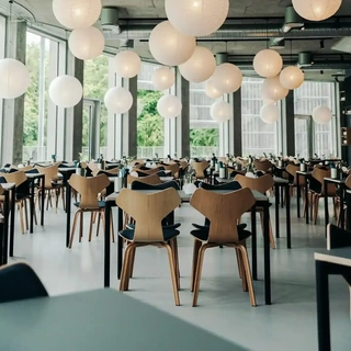 Spacious dining area at Tivoli Friheden featuring Grand Prix chairs by Fritz Hansen – ideal for versatile and stylish hospitality layouts.