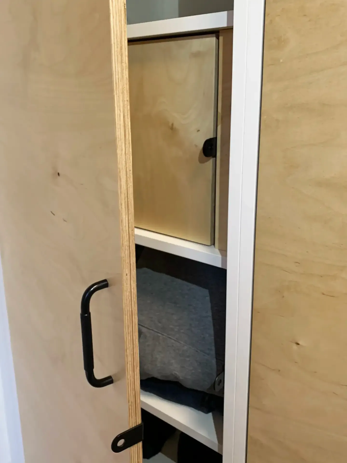 Interior of school locker cabinet with custom-built shelves, optimized for private belongings, and daily essentials.